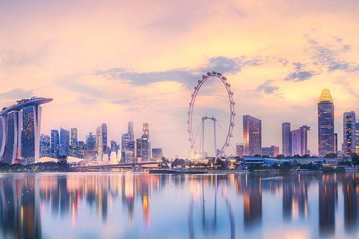 Skyline with Ferris wheel and modern skyscrapers at sunset
