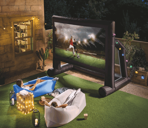 Outdoor movie night with inflatable screen and cozy seating