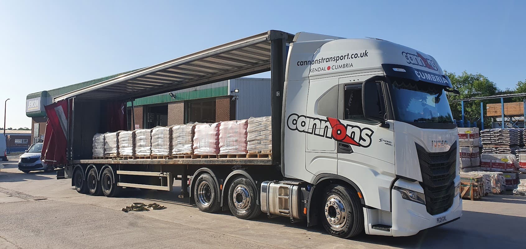 A large truck unloading pallets at Jewson Rotherham, an ironmongers in Eastwood, Yorkshire.