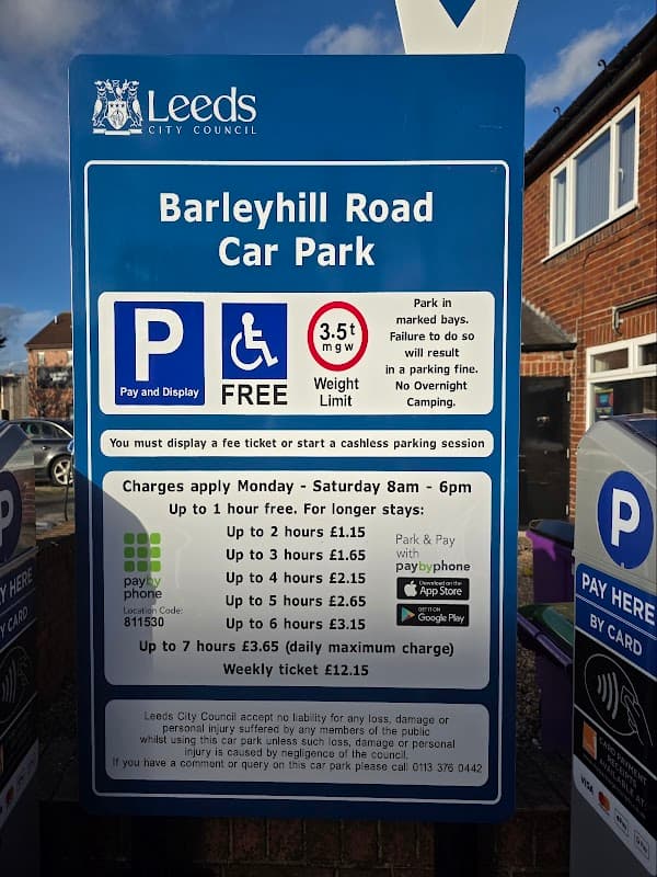 Sign for Barley Hill Road Car Park in Garforth, Yorkshire, detailing free parking and payment options.