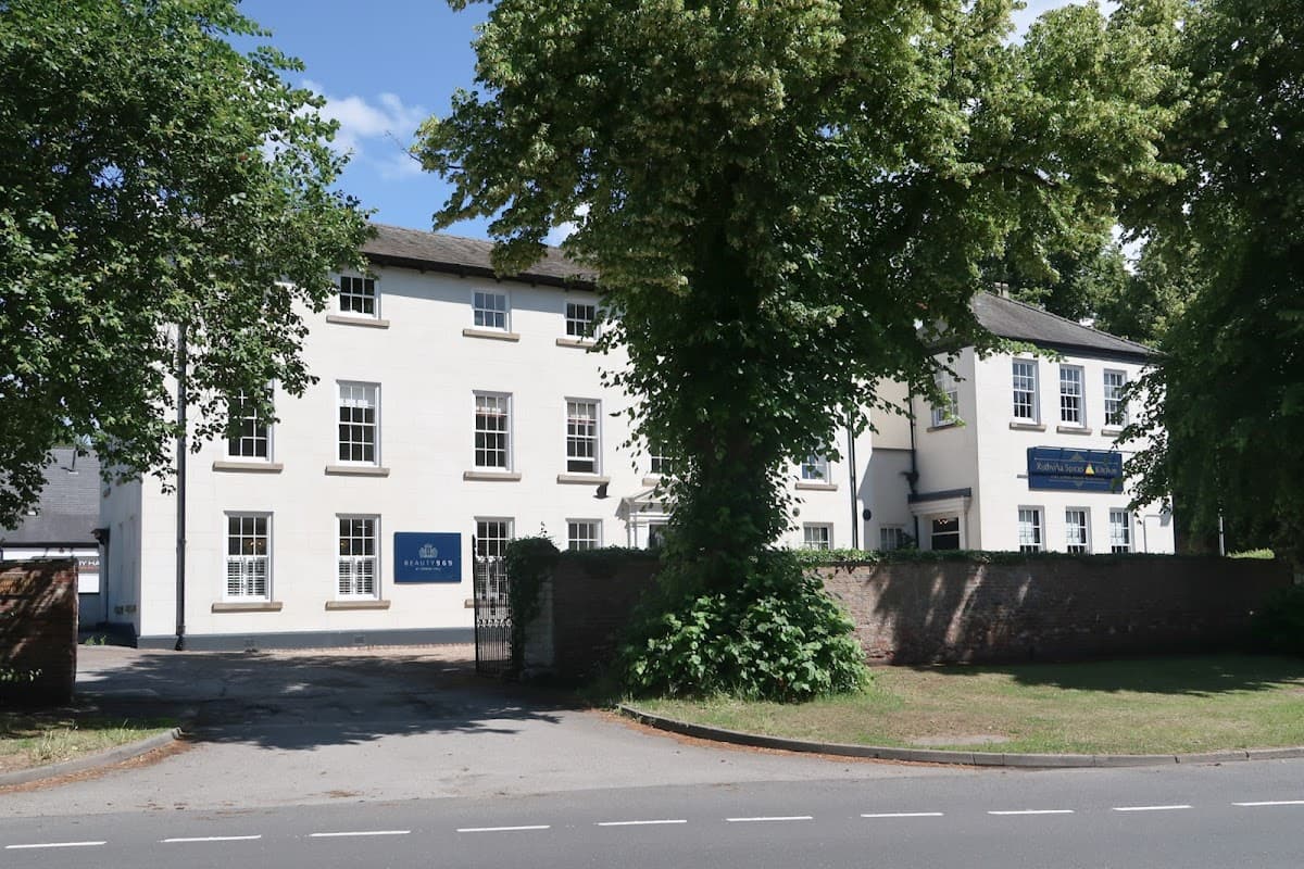 White building with large windows, surrounded by trees and a grassy area, located on a street in North Ferriby.