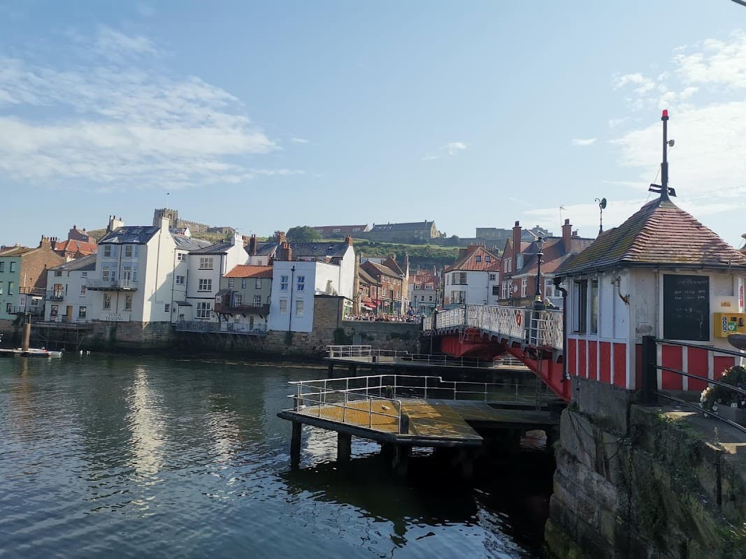 Cliff Street Car Park with waterfront views, colorful buildings, and a bridge in Whitby, Yorkshire.