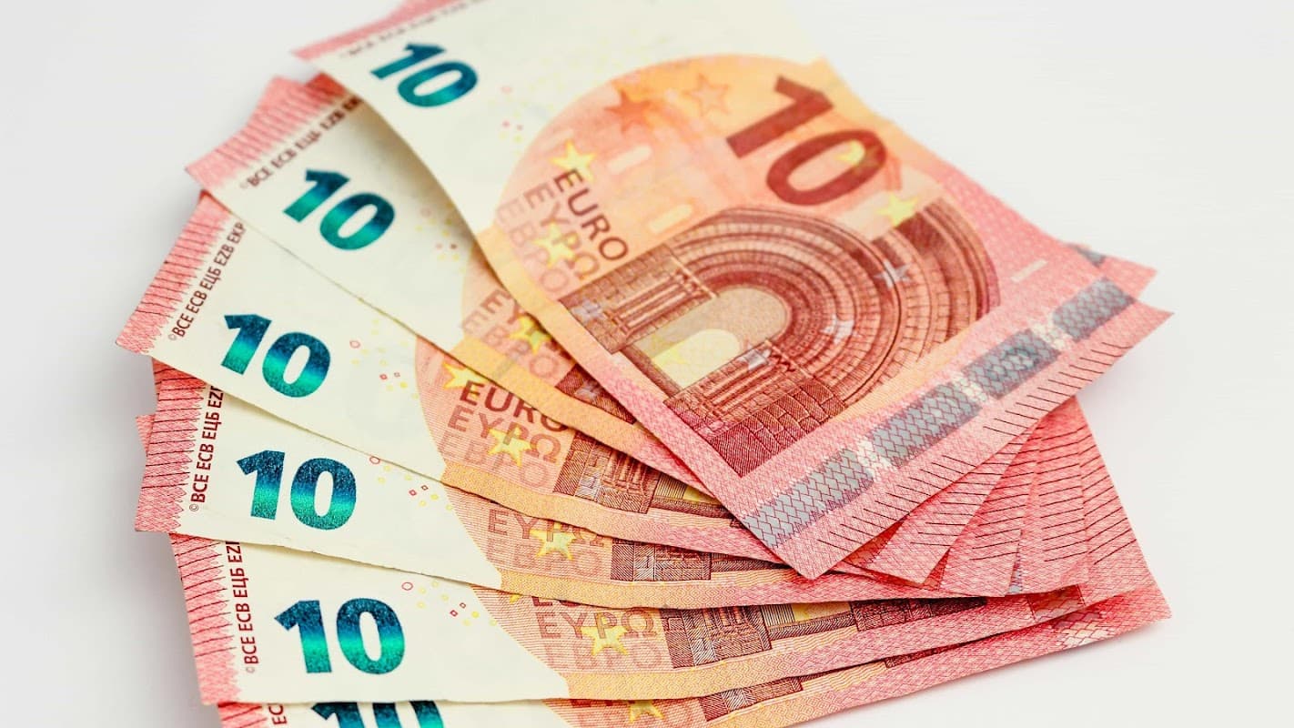 Stack of ten euro banknotes, each displaying the denomination prominently, showcasing vibrant colors and intricate designs.