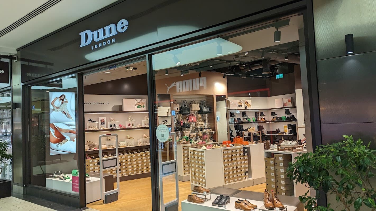 Dune York Outlet storefront showcasing a variety of shoes and accessories, with a modern display and bright lighting.