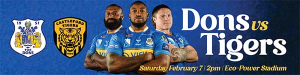 Three rugby players in blue jerseys stand confidently, with team logos and match details displayed prominently.