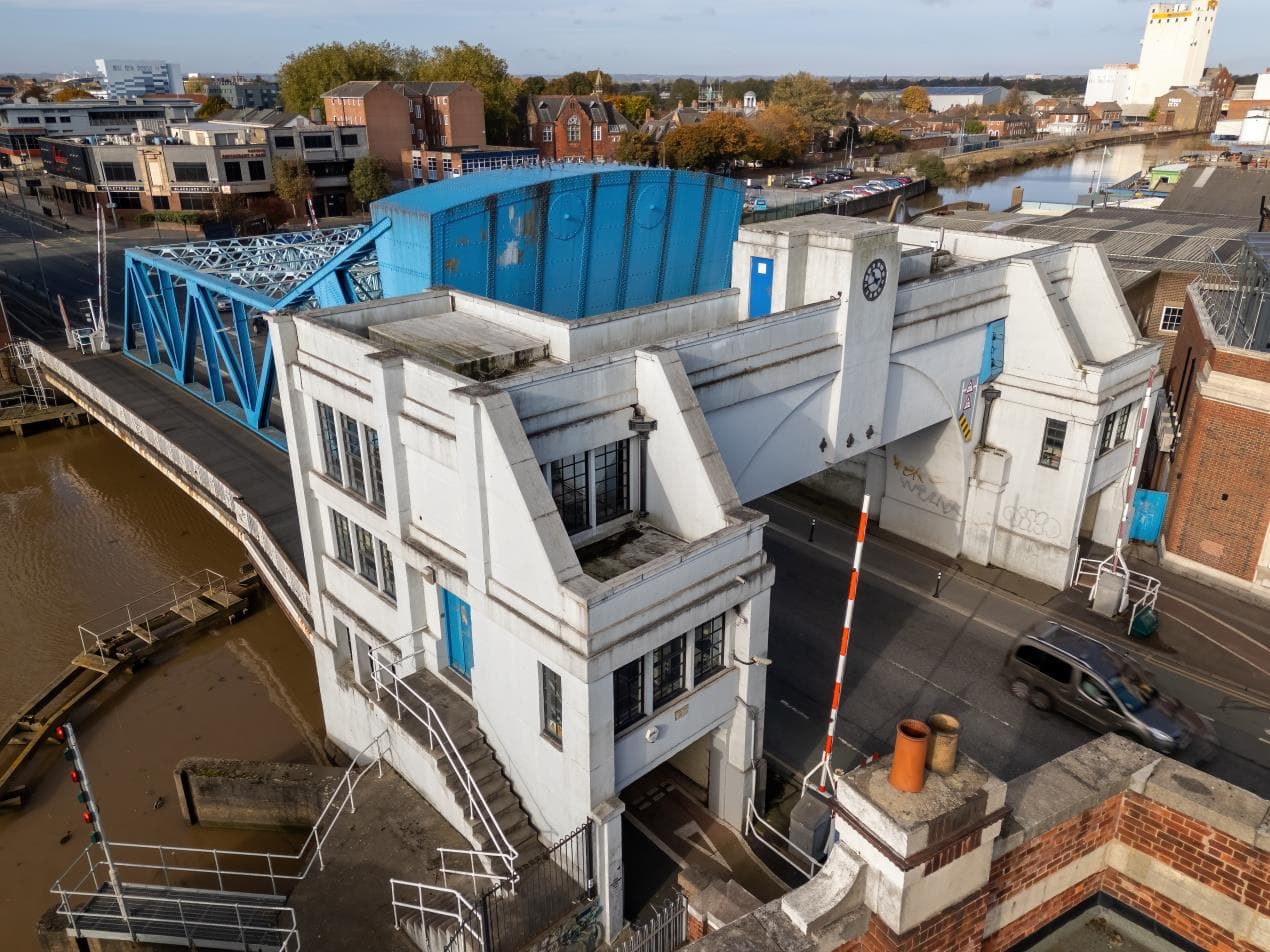 North Bridge in Yorkshire, showcasing its distinctive blue structure and surrounding urban landscape under clear skies.