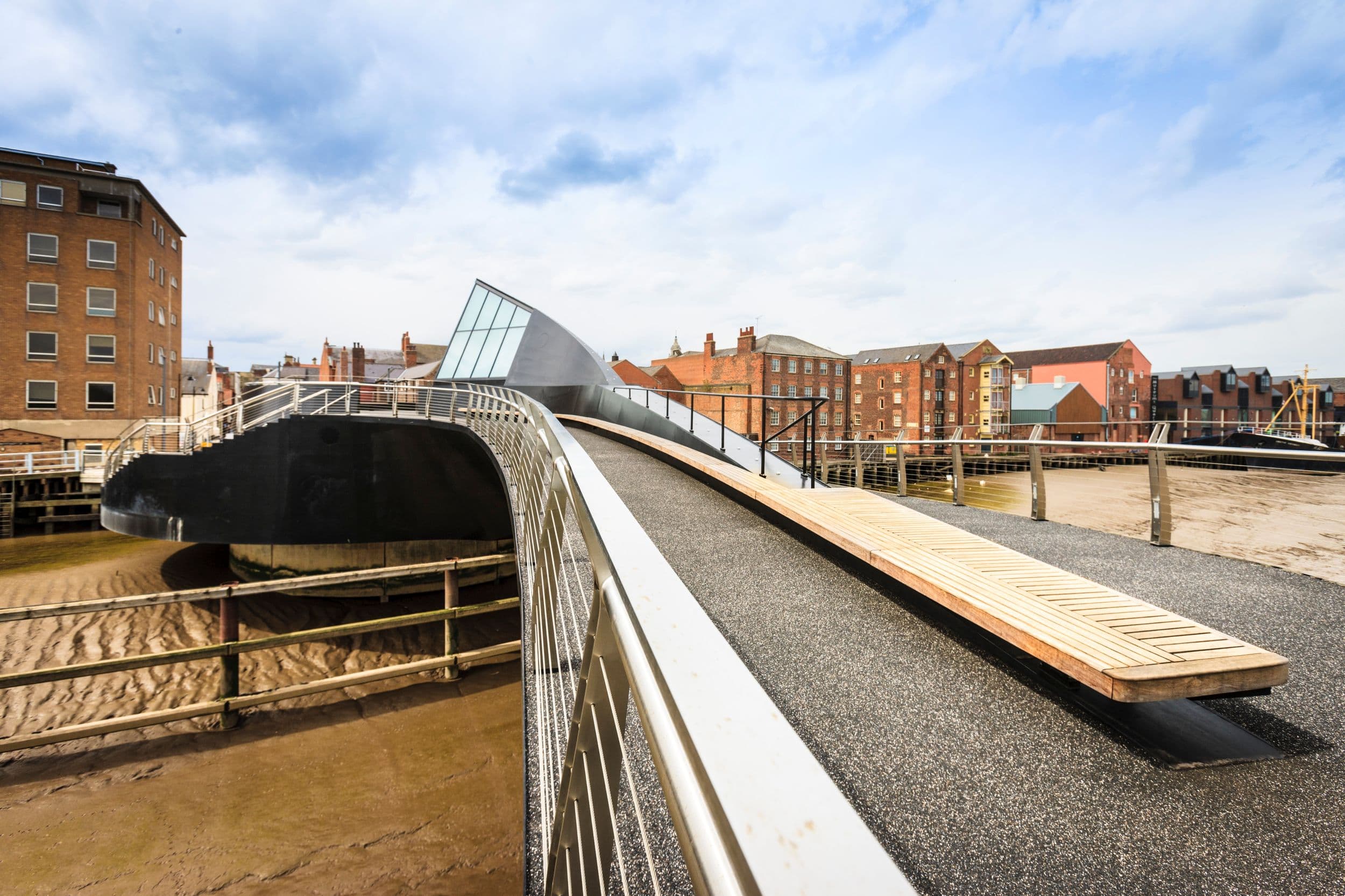 Curved modern pedestrian bridge over river in Yorkshire town