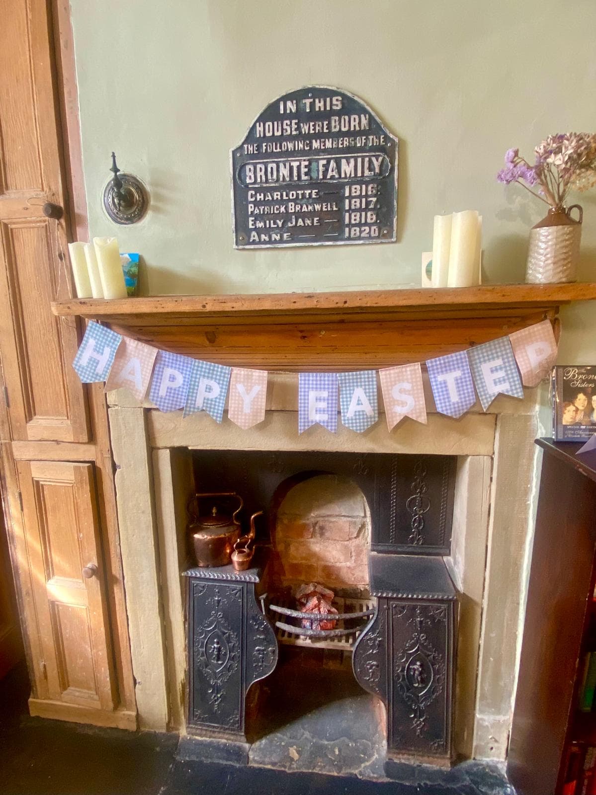 Rustic fireplace with Brontë plaque and Easter banner