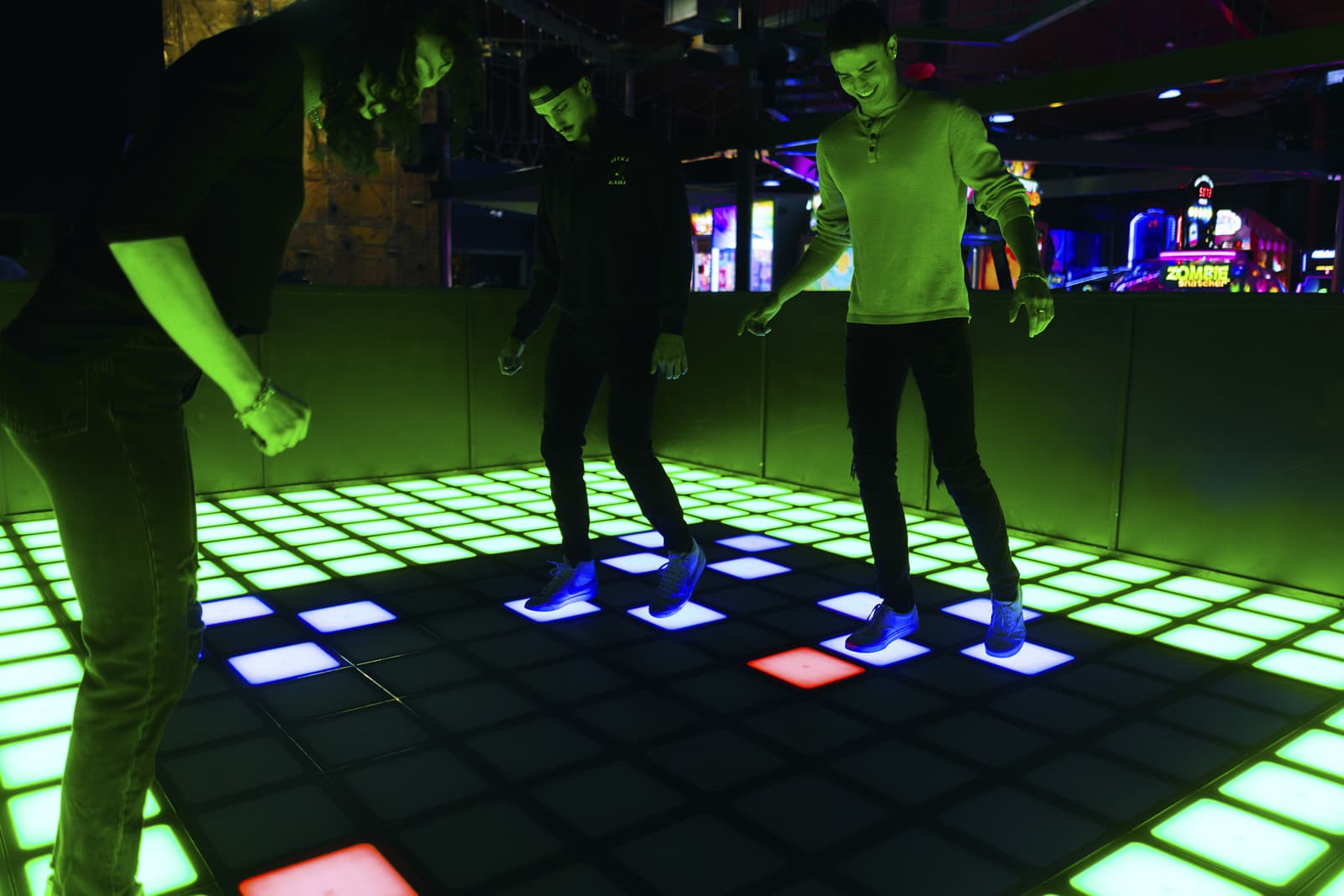 People enjoying interactive illuminated dance floor