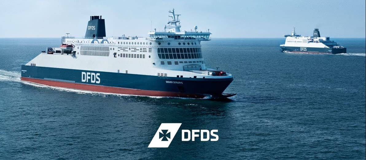 Two large DFDS ferries sailing on a calm blue sea
