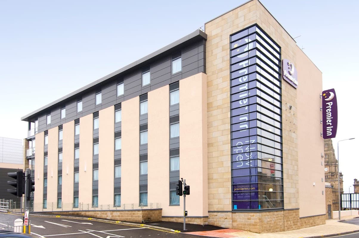 Modern building with large windows, featuring the Premier Inn sign and a pedestrian crossing in Halifax, Yorkshire.