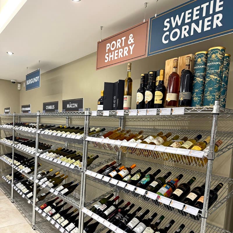Wine shelves displaying various bottles labeled "Port & Sherry," "Sweetie Corner," "Burgundy," "Chablis," and "MΓ’con."
