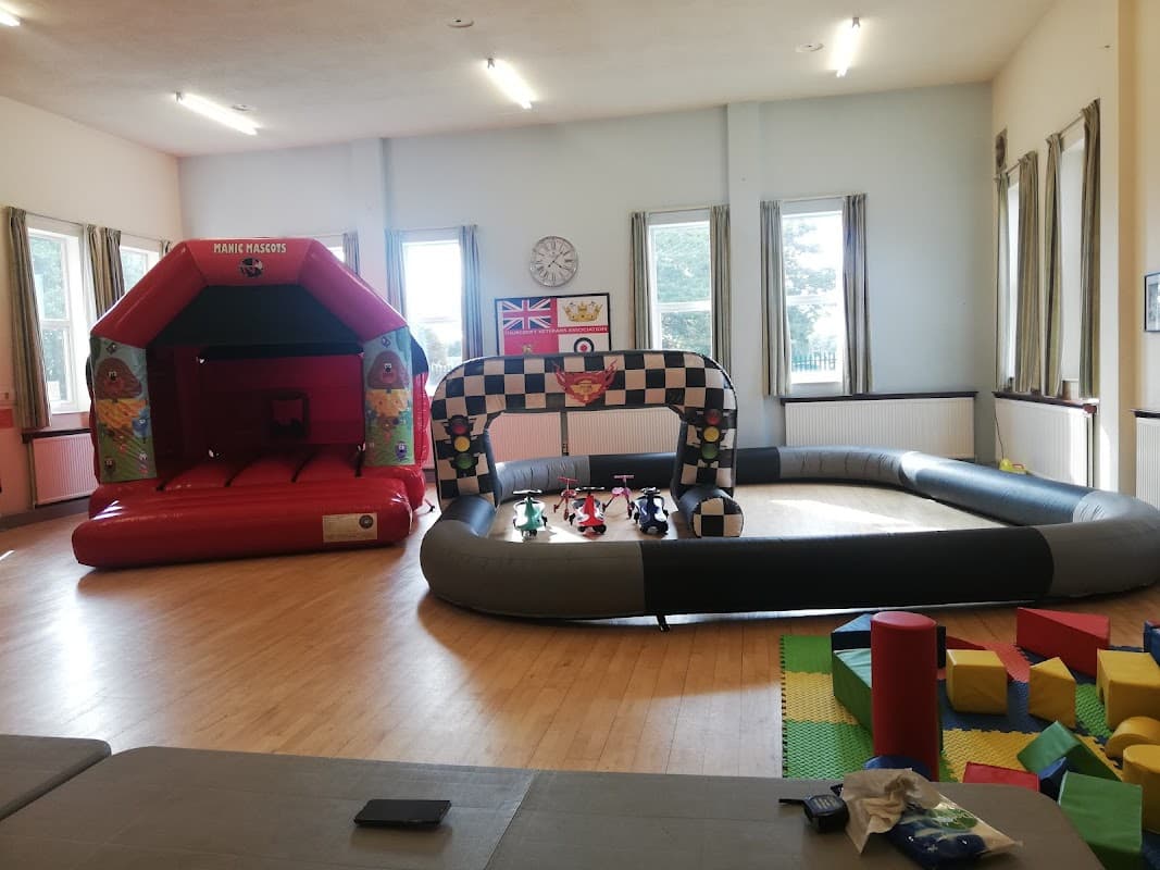 Bright indoor space featuring a bouncy castle, a racing track, and colorful play blocks in Thurcroft, Yorkshire.
