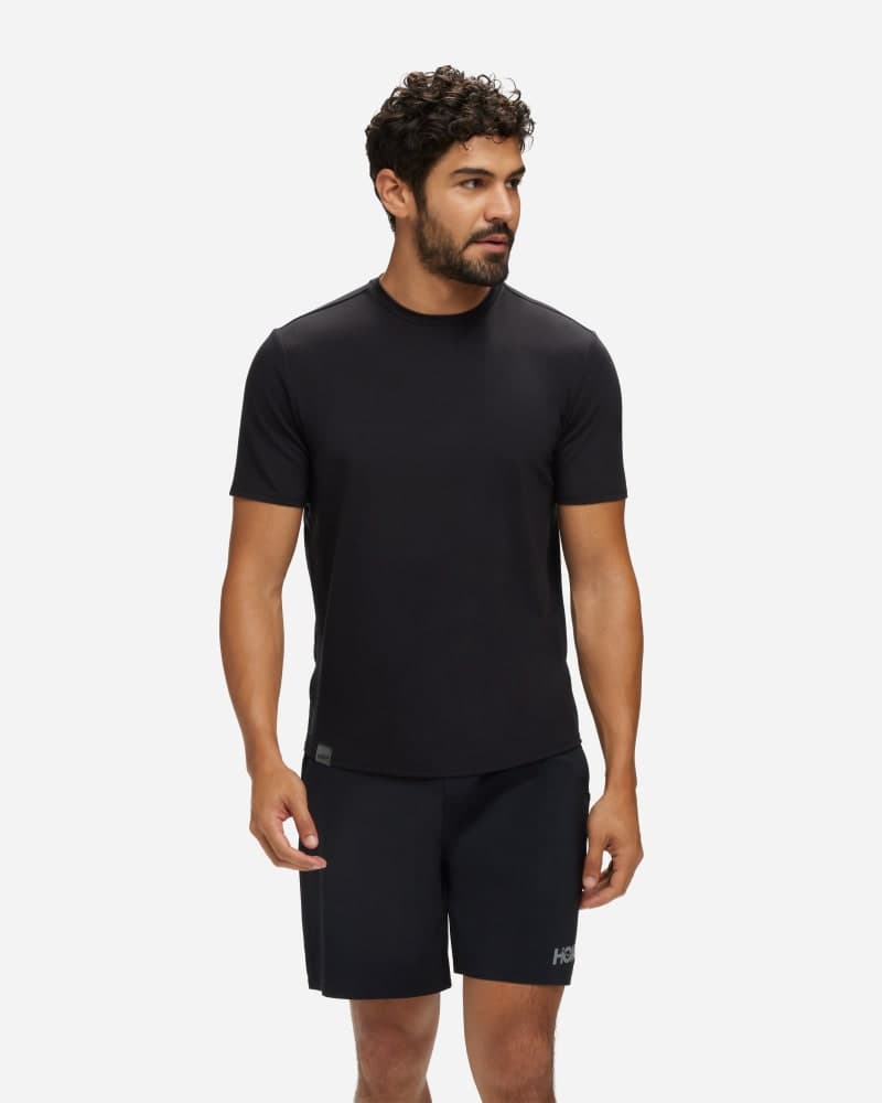 Men's HOKA Essential Shirt in large size, featuring a sleek black design, short sleeves, and a lightweight, breathable material ideal for active wear.