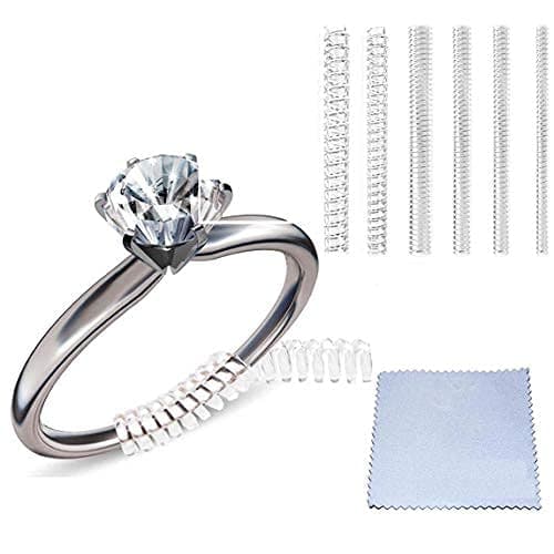 Clear silicone ring size adjusters in four sizes, designed to fit loose rings, accompanied by a polishing cloth and 12 pieces of ring guards for secure fitting.