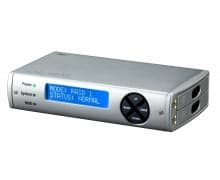 Silver aluminium enclosure with a blue LCD display, featuring buttons for power and mode selection, and dual drive bays for RAID configuration.