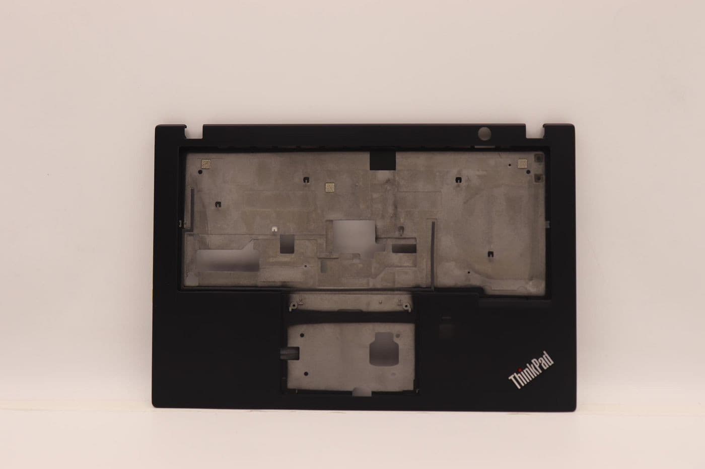 Black Lenovo keyboard base with a smooth surface, featuring cutouts for keys and a fingerprint reader, marked with "ThinkPad" logo in the bottom right corner.