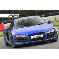 Blue Audi R8 V10 sports car on a track, with PSR Experience branding on the front license plate.