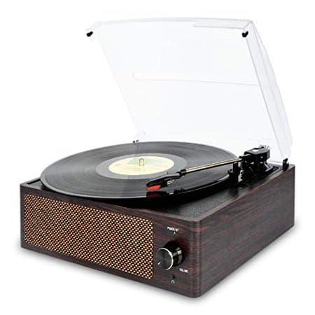 Bronze Cotsoco Bluetooth belt drive turntable features a wood finish, clear dust cover, and a control knob, with a vinyl record playing on the turntable.
