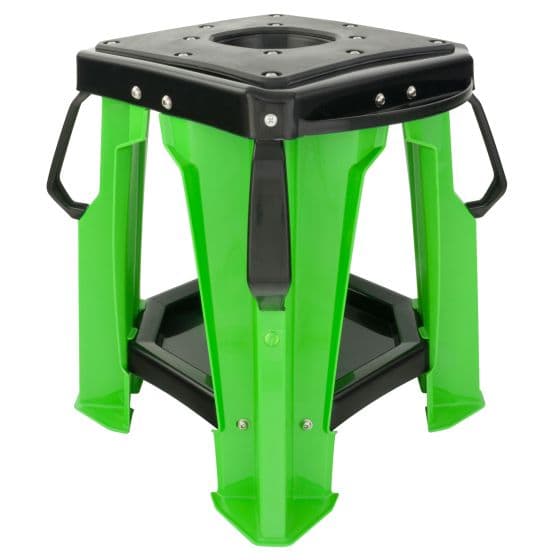 Green plastic motocross bike stand with a black top, featuring a hexagonal shape, sturdy legs, and handles for easy transport.