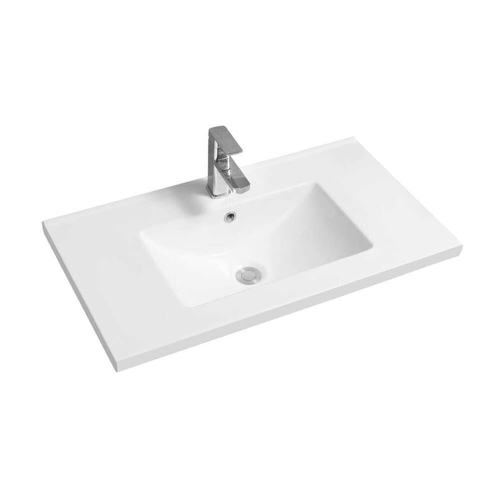 White ceramic inset basin with a scooped mid-edge design, featuring a central drain and sleek silver faucet, set on a rectangular countertop.