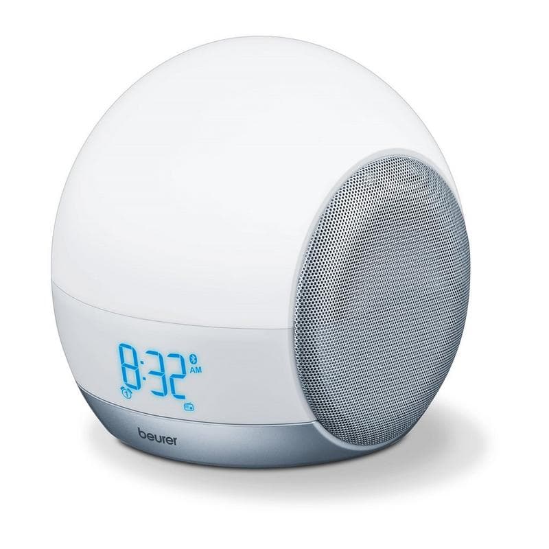 Round white wake-up light with a silver speaker grille, blue digital clock display showing 8:32 AM, designed for mood enhancement and gradual light simulation.
