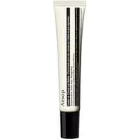 White Aesop lip salve tube with black text, cedar and citrus formula, 9 ml size, sleek design for dry skin nourishment.