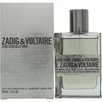 Clear glass bottle with silver cap, labeled "Zadig & Voltaire This Is Really Him!" next to matching silver box.