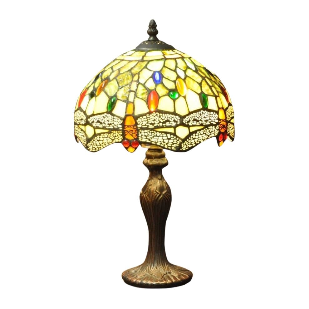 Tiffany-style lamp featuring a green dragonfly design on a stained glass shade with colorful accents, supported by an ornate bronze base.