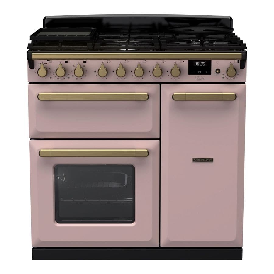 Pale pink dual fuel range cooker with antique brass knobs and handles, featuring a black gas hob and a large oven with a glass door, showcasing a sleek and stylish design.