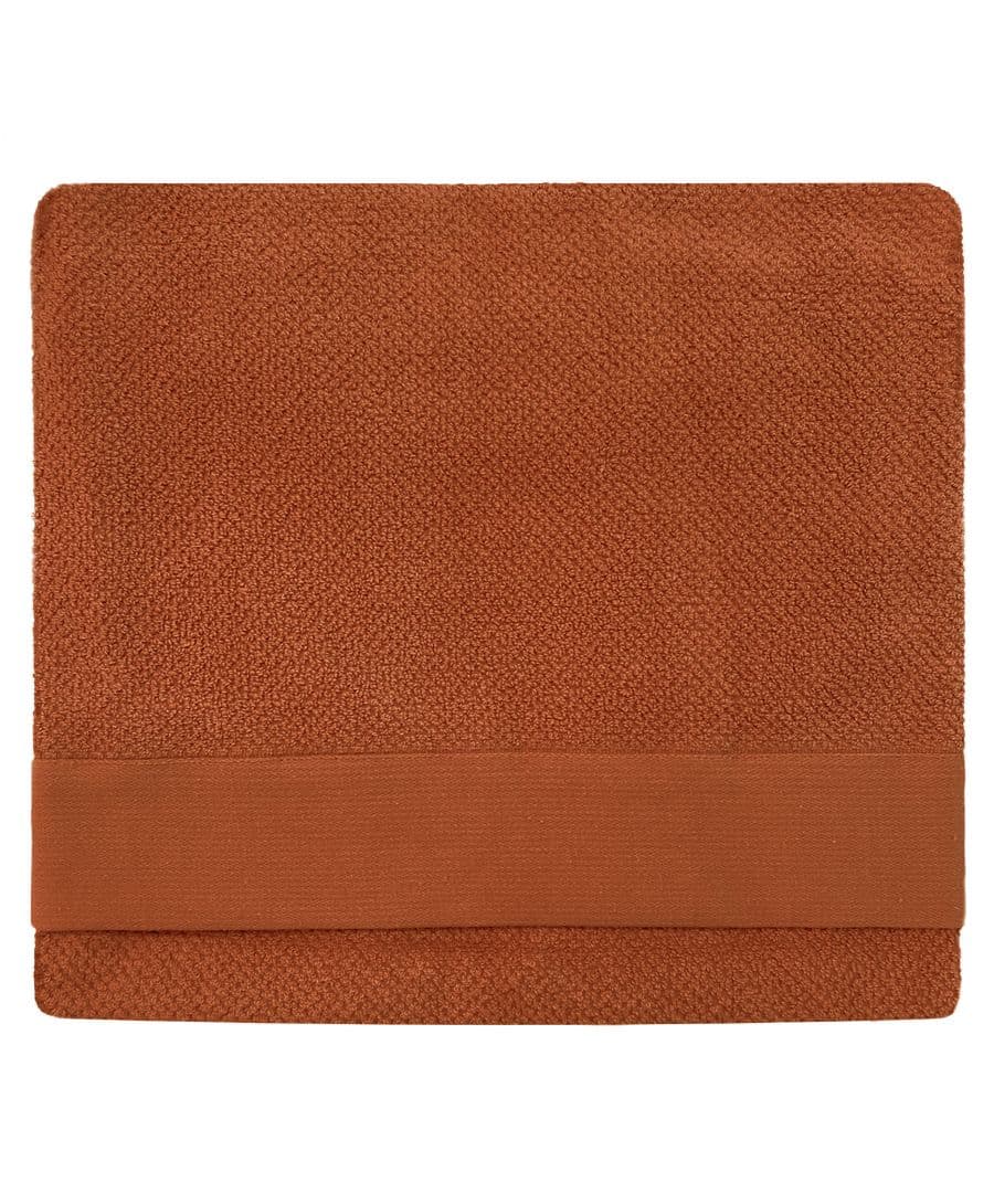 Textured brown cotton bath sheet with a soft, woven surface and a solid band along one edge, designed for comfort and absorbency.