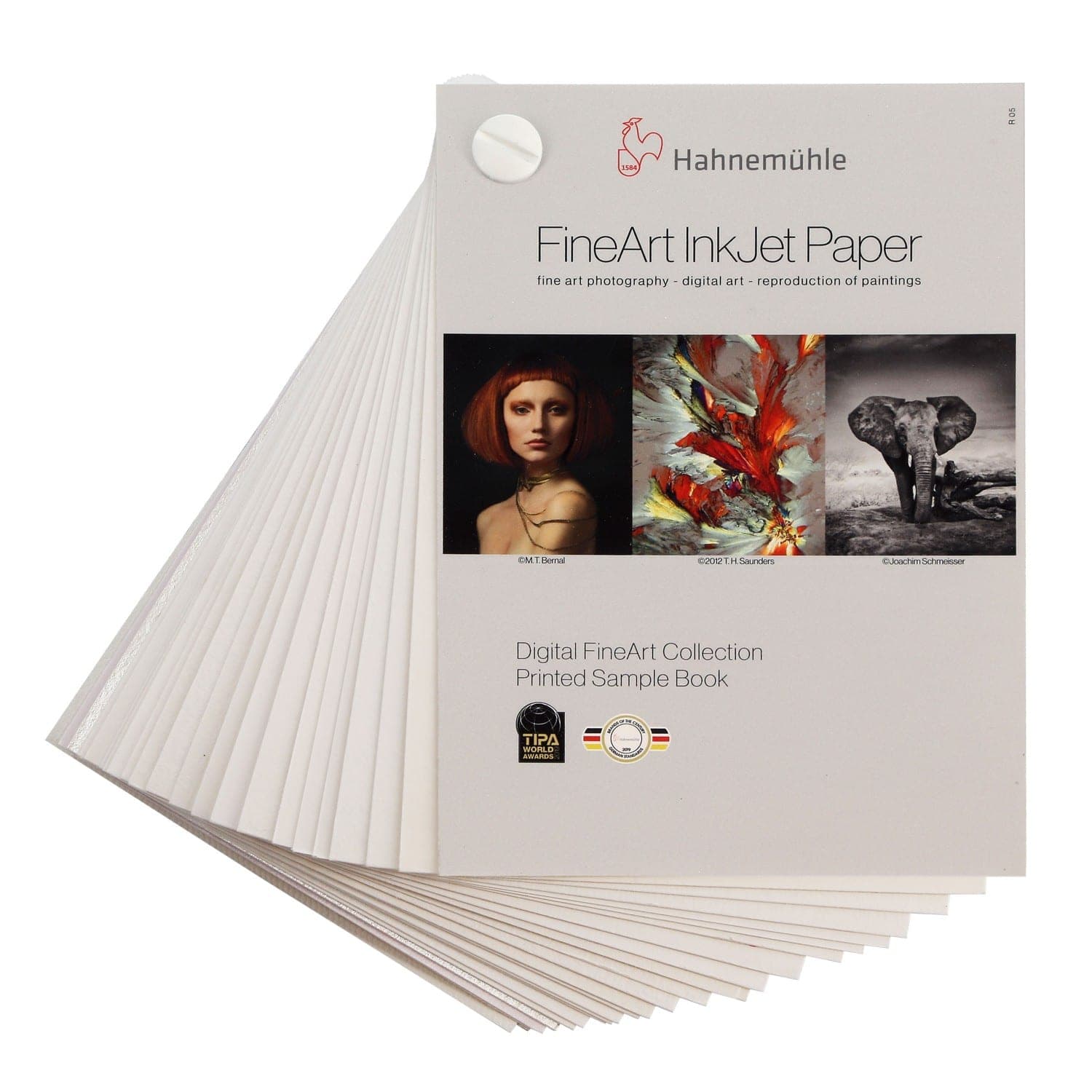 A printed sample book featuring Hahnemühle's FineArt InkJet Paper, showcasing various art prints, with a white cover and a circular tab at the top for easy handling.