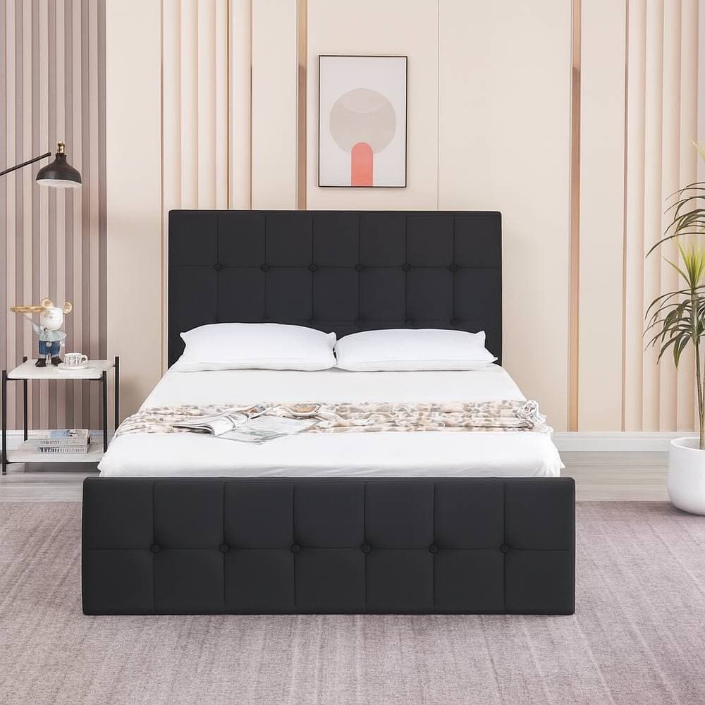 Black velvet ottoman bed with gas lift storage, featuring a cushioned headboard and a small double size, set against a modern bedroom backdrop with light-colored walls.