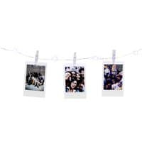 Fujifilm Instax LED string lights with clear hanging pegs, displaying three instant photos.