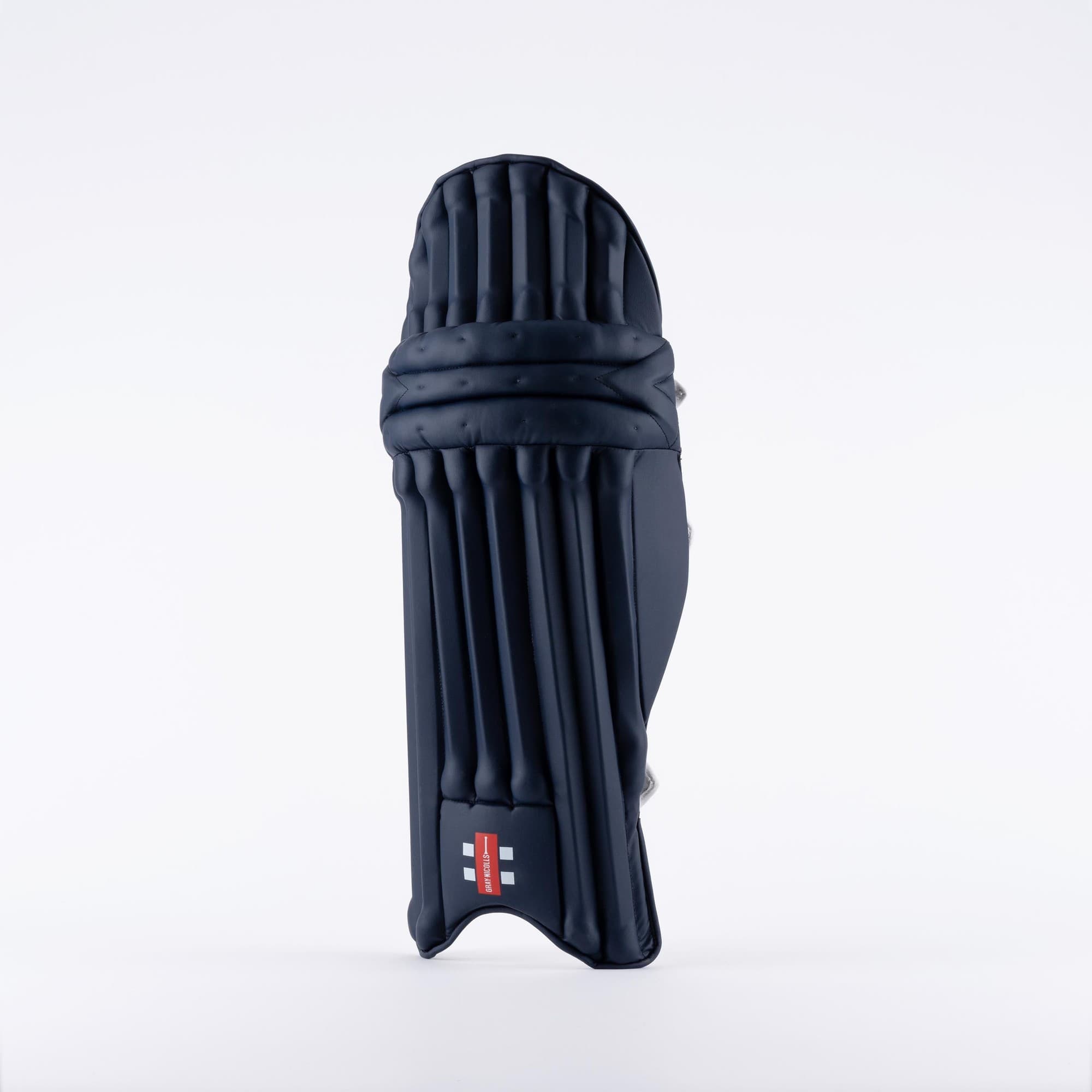 Black Gray-Nicolls Prestige batting pads featuring a sleek design, made from durable materials with prominent vertical grooves for enhanced protection and flexibility.