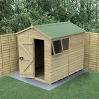 Wooden apex shed with green roof, single door, and two windows, featuring tongue and groove panels on concrete base.