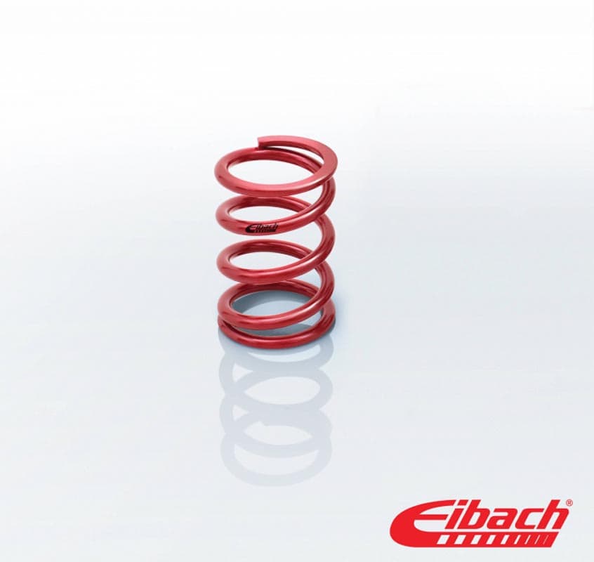Red coil spring made of metal, featuring a smooth finish and a tight spiral design, with the Eibach logo visible at the base.