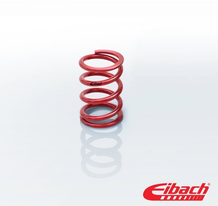 Red coil over spring by Eibach, measuring 2.25 inches in diameter and 6 inches in height, featuring a smooth, shiny metal finish with distinct spiral coils.
