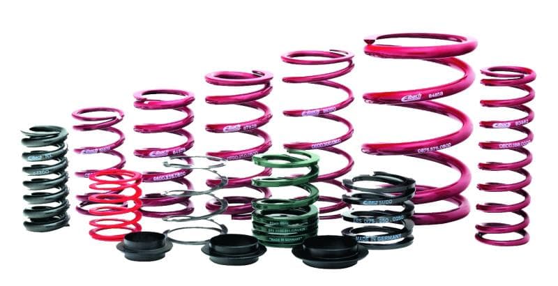 Eibach ERS coil over springs in various sizes, featuring a vibrant pink finish, with some black and green components, designed for high-performance suspension systems.