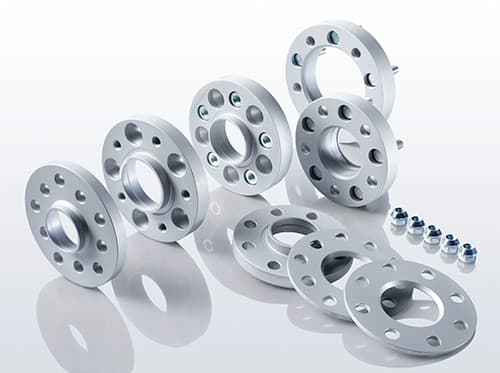 Eibach S90-6-15-027 wheel spacers in silver aluminum, featuring multiple holes for bolts, arranged in two sizes with accompanying blue bolts.