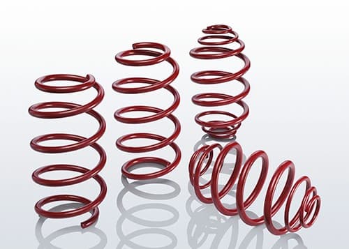 Red coil springs from the EIBACH E20-65-001-01-22 Suspension Kit, showcasing a smooth finish and varying heights for enhanced vehicle performance.
