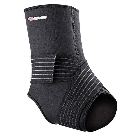 Grey ankle stabilizer made of neoprene with a supportive strap, featuring a snug fit and an open heel design for comfort and mobility, labeled with the EVS logo.