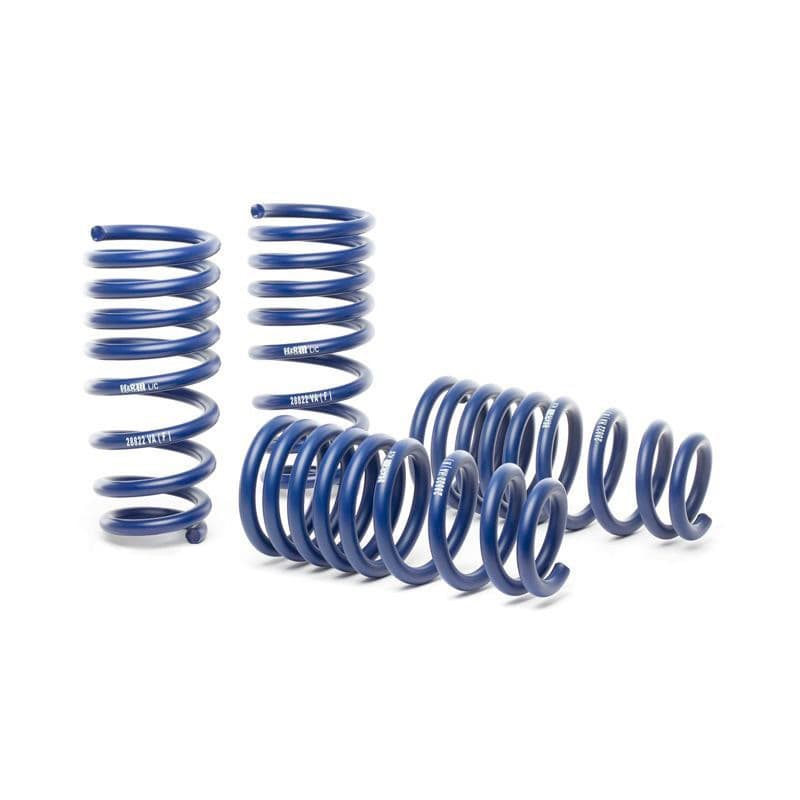Four blue coil springs are arranged, showcasing a performance lowering suspension kit by H&R, made from durable metal with a smooth finish and distinct spiral design.