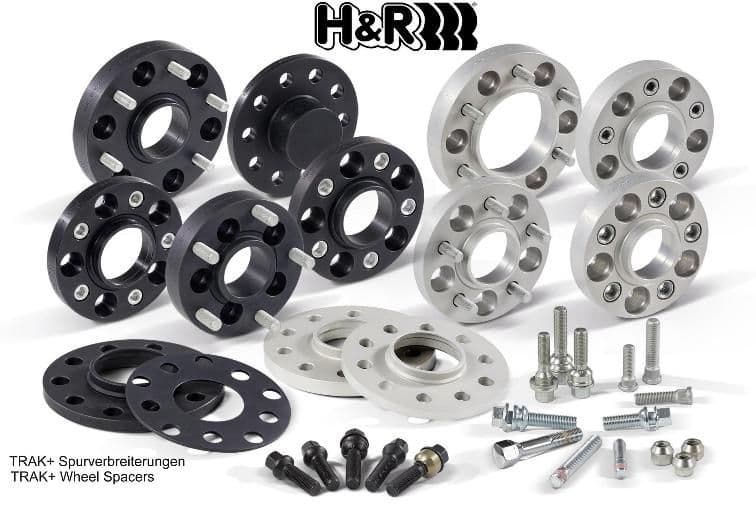 H&R TRAK+® wheel spacers in black and silver, featuring 4 holes, 5mm thickness, and accompanying bolts, arranged in a neat display.