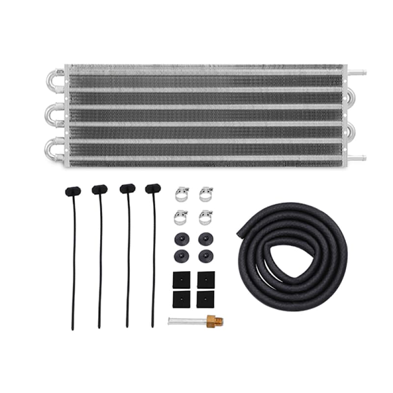 Mishimoto Universal Transmission Fluid Cooler in silver aluminum, measuring 20 x 7.5 x 0.75 inches, with mounting hardware, hoses, and black rubber grommets included.