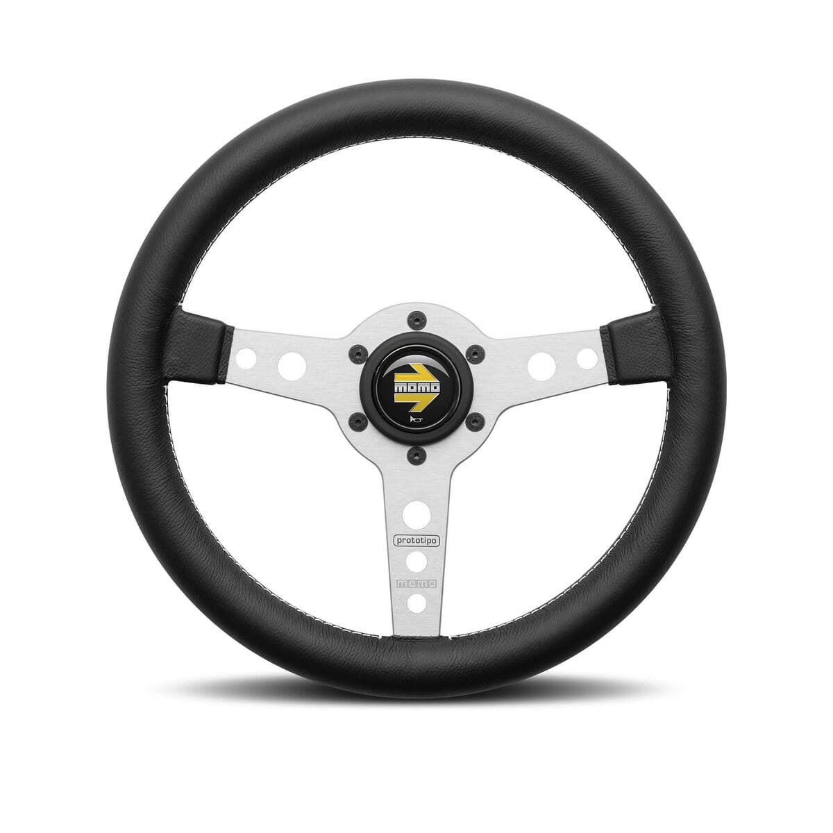 Black leather steering wheel with a 370mm diameter, featuring a silver aluminum center hub, three spokes, and the Momo logo prominently displayed in the center.