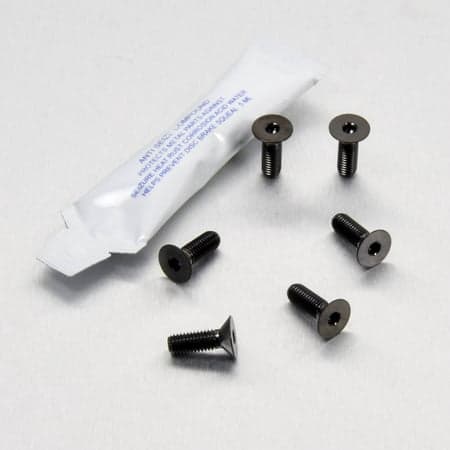 Pro-Bolt stainless steel footrest heel plate bolt kit in black, featuring six black screws and a small packet of anti-seize compound for installation.