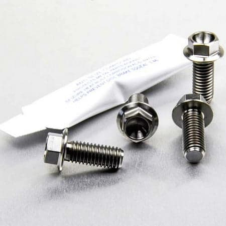 Pro-Bolt Titanium Pillion Footrest Hanger Bolt Kit in silver, featuring four metallic bolts with hexagonal heads and threaded shafts, packaged with a protective sleeve.