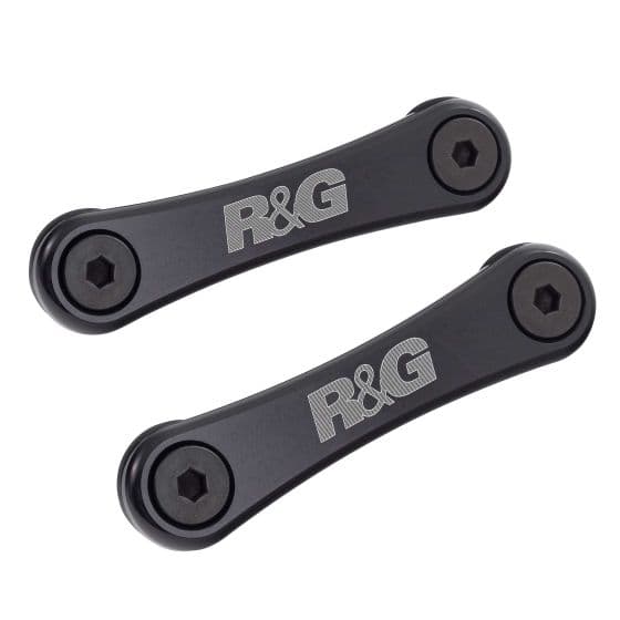 Black aluminum rear footrest blanking plates by R&G, featuring a sleek design with engraved logo and two hexagonal bolt holes for secure installation.