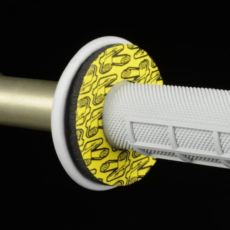 Yellow and black rubber donut grip with a textured white handle, designed for enhanced comfort and control on motorcycle handlebars.